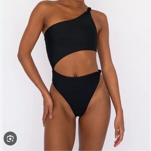 Skatie swimsuit one piece size large style is Nicole. Brand new without tags